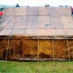 Leather tent based on finds from Vindolanda and other sites. Image: MCB Side view of a contubernium tent made of tan-coloured leather panels stitched together.