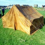 Leather tent based on finds from Vindolanda and other sites. Image: MCB Gable-end view of a contubernium tent made of tan-coloured leather panels stitched together.