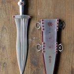 Reconstructed (by the Ermine Street Guard) dagger and scabbard, based on an amalgam of more than one design. Image: MCB On the left, a reconstructed dagger, and on the right, a reconstructed dagger scabbard with silver and red enamel inlay.