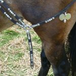 Replica ring junction from horse harness, with four junction loops attached. Reconstructed by the Ermine Street Guard. Image: MCB Harness fittings of tinned copper alloy for a ring junction, consisting of a ring with four strap loops attached, each attached to a leather harness strap.