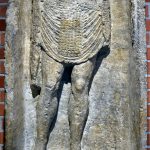 Tombstone of Hyperanor, auxiliary archer of cohors I Sagittariorum. He holds a bow in his left hand and has his right hand on his sword hilt. He wears two belts, one each for sword and dagger, and has an eight-strapped apron. Image: Marcin Szala Infantryman stands within a niche, with his right hand on his sword hilt and a composite bow in his left. The tombstone is missing its head.