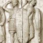 Portion of the so-called Altar of Domitius Ahenobarbus depicting two legionaries (with large, curved, oval shields, mail body armour, crested helmets, and sheathed swords), one of whom appears to be saluting. Image: jastrow (PD) Two legionaries with large oval shields facing away from each other.