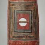 The curved rectangular shield from Tower 19 at Dura-Europos in its current state. Image: Yale Art Gallery A curved rectangular painted shield with a horizontal grip but lacking a boss. An elaborate paint scheme includes a lion in the lower register, victories with wreaths flanking an eagle in the top, and decorative bordering to where the the boss plate should be.