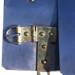 Detail of the horizontal hinged buckle and vertical fastener of a Corbridge type B/C cuirass. Reconstructed by the Ermine Street Guard. Image: MCB Close-up showing brass fittings on steel plate.