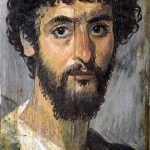 Portrait of a bearded soldier with a studded baldric over his left shoulder. From Fayum (EGY). The studs are gilded (brass or gold?). He wears a white tunic and a blue sagum over his left shoulder. Image: Yann (PD) Bust of a bearded soldier with curly, dark hair facing slightly to his left has his head turned to the right to look at the viewer.