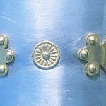 Detail of the lobate hinges and decorated washer around rivets on an upper shoulderguard of a Corbridge type B/C cuirass. Reconstructed by the Ermine Street Guard. Image: MCB Close-up showing brass fittings on steel plate.