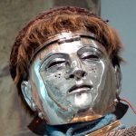 Cavalry 'sports' helmet from Nijmegen with woven 'hair net'. Image: Wolfgang Sauber Side view of a cavalry face-mask helmet with a silvered face mask and a woven covering over the helmet bowl.