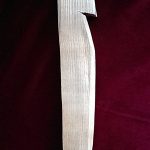 Modern tent peg made of wood, virtually identical to Roman examples. Image: MCB A wooden stake, rectangular in section, tapering to top and bottom, with a flat top and a notch in one side.