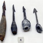 Four plumbatae from Enns (AUT) in the Museum Lauriacum. Image: Wolfgang Sauber (CC BY-SA 3.0) Four plumbatae laid out and left to right, from longest to shortest, with barbed heads and weights of varying lengths.