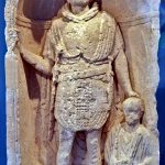 Tombstone of the auxiliary infantryman Firmus of cohors Raetorum, found in Andernach and now in Bonn. Image: MCB (CC BY-SA) Roman soldier stands in a niche, holding two spears in his right hand and an oval shield in his left.