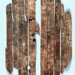 Painted oval plank shield found in Tower 19 at Dura-Europos. A figure of a military god is depicted. Image: Yale University Art Gallery (PD) Fragmentary painted oval shield made up of planks laid out on a white sheet.